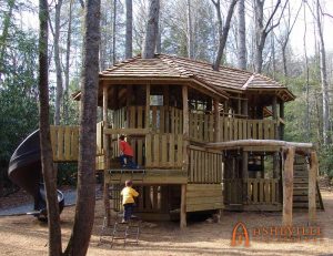 Large treehouse playground with a cedar roof. Built for Southcliff Community in Fairview, NC - Asheville Playgrounds