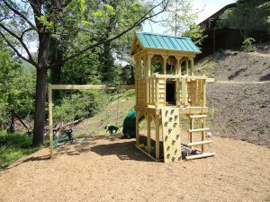 Fort with porch, log climber, rock wall and swings - Asheville Playgrounds