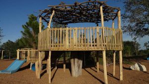 Huge deck with locust stump and woven rhododendron roof for shade - Asheville Playgrounds