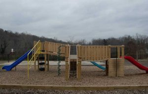 Playground with three slides and multiple platforms connected by bridges at the Asheville Christian Academy in Swannanoa, NC - Asheville Playgrounds