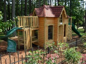 Playhouse styled to match the home it's adjacent to - Asheville Playgrounds