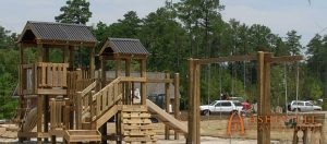 Playground with swings, benches and covered decks at The Haven at Windsor Lake - Asheville Playgrounds
