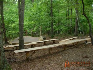 Locust slab benches surround this rustic amphitheater at Rock Ridge Park in Pittsboro, NC - Asheville Playgrounds