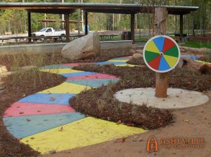 Outdoor game spinner and colored board path at White Deer Park - Asheville Playgrounds