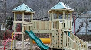 Playground with climbing wall, spiral slide, and crawl tunnel at the KOA campground in Swannanoa, NC - Asheville Playground