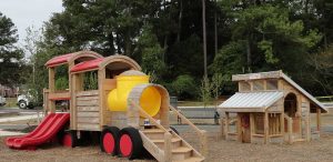Train and chicken coop play sets in Knightdale Station Park - Asheville Playgrounds